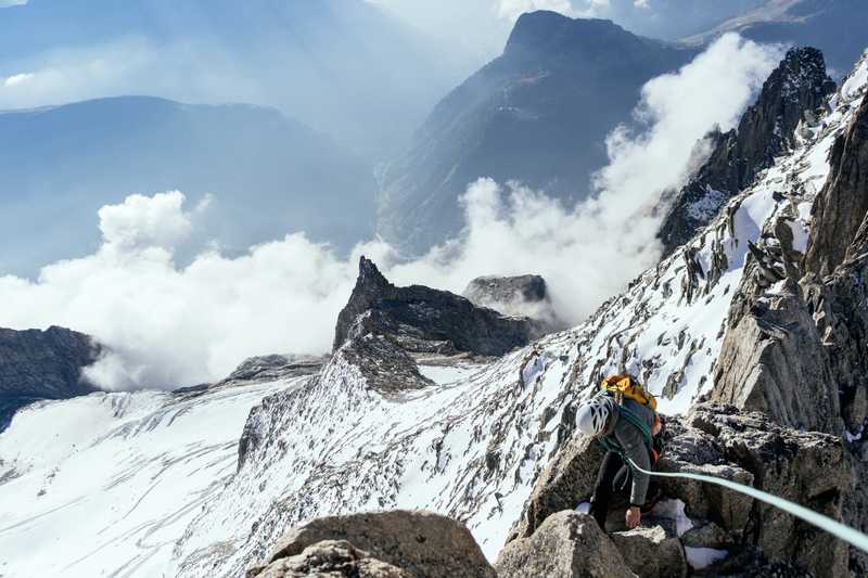 Taylor Burk walking along a knife edge arete