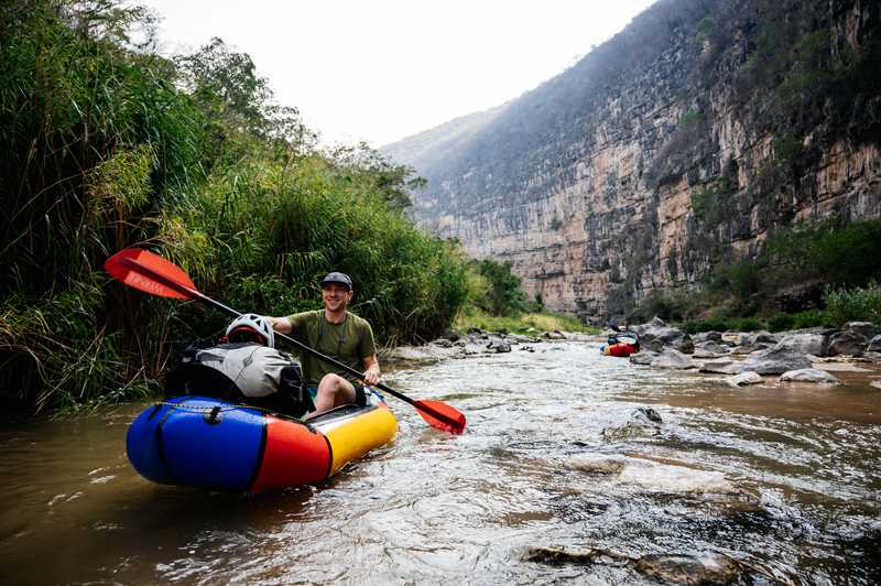 Packup co-founder Taylor Burk in a pack raft