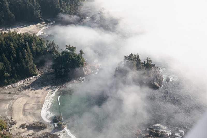 Aerial view of a bay in Tofino with clouds rolling in
